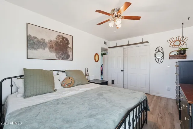 a bedroom with a bed and a chandelier