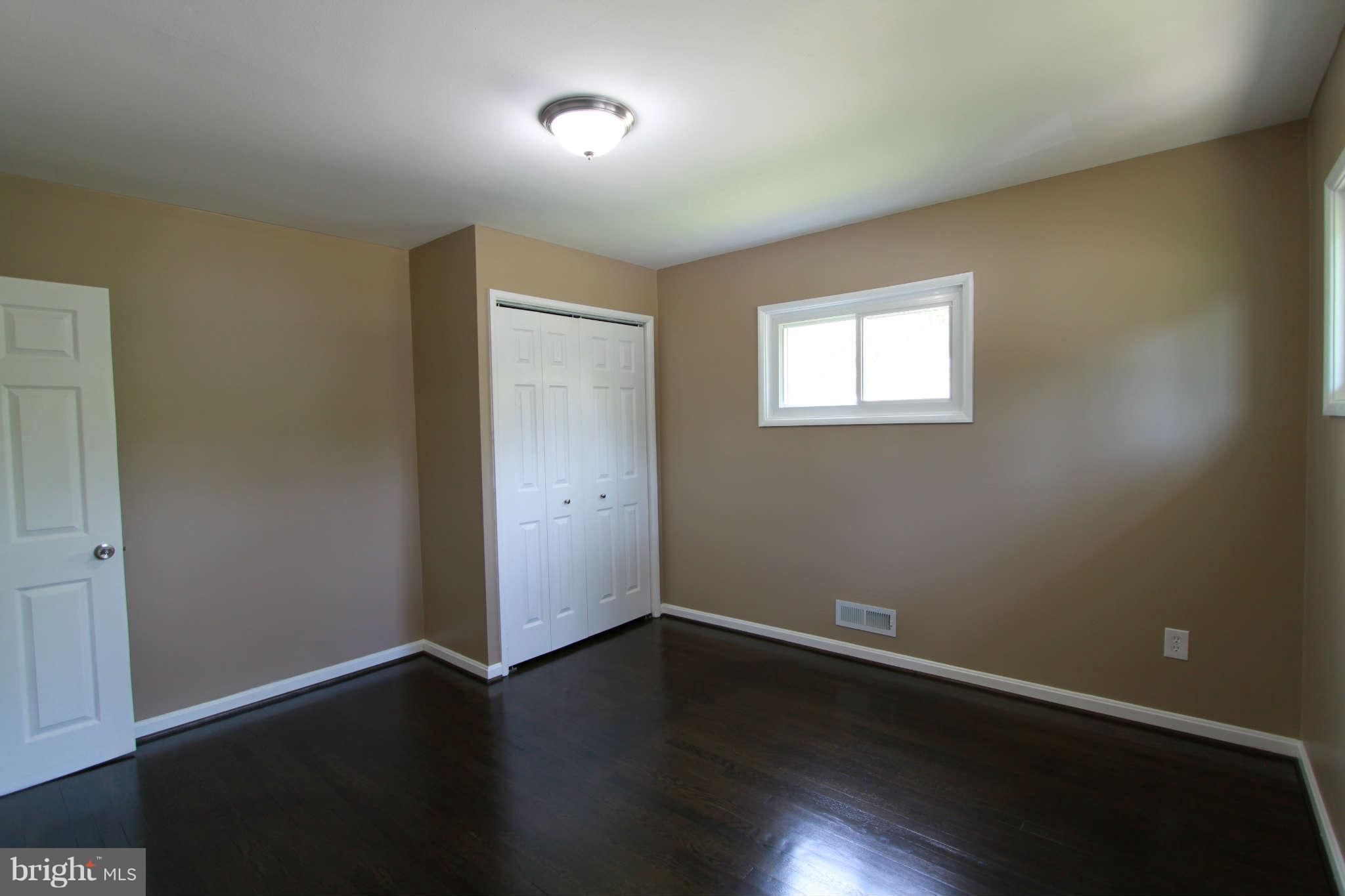 1020 Marksworth Road Baltimore, MD 21228 - Photo 14 of 30 an empty room with wooden floor and windows