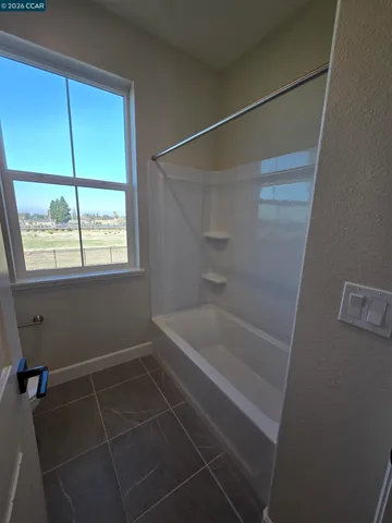 a bathroom with a window and a shower