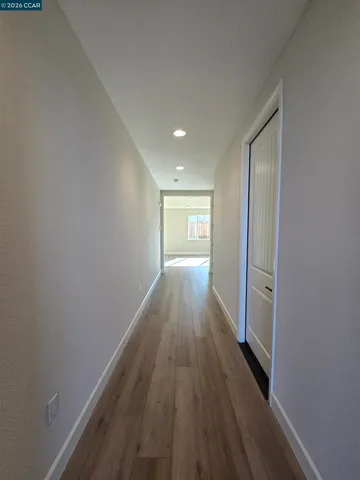 a view of a hallway with wooden floor
