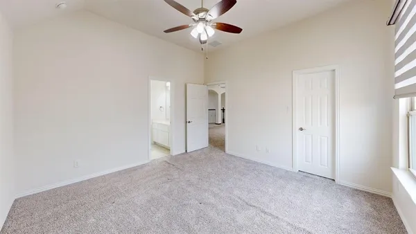 a view of an empty room with a ceiling fan