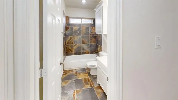 a bathroom with a bathtub and a shower