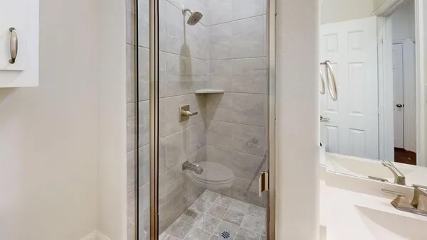 a bathroom with a sink toilet and shower