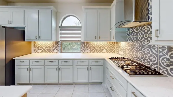 a kitchen with cabinets appliances and a window