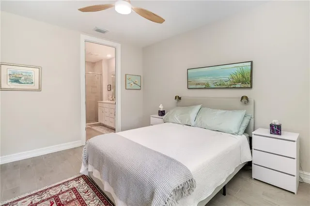 a bedroom with a bed and a painting on the wall