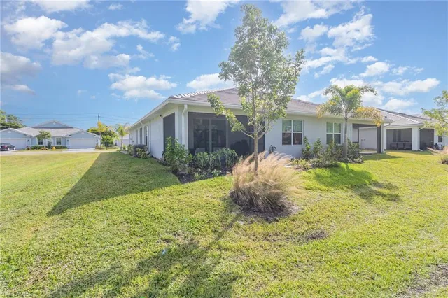 a front view of house with yard and trees around