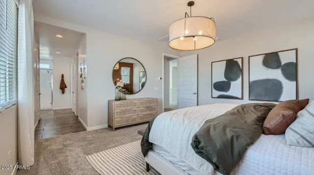 a bedroom with bed and a large window