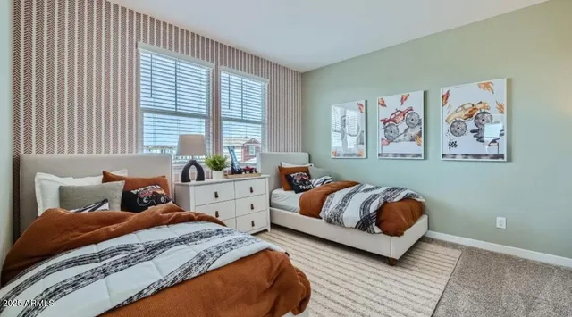 a bedroom with a bed and a potted plant