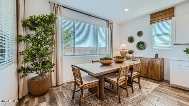 a kitchen with stainless steel appliances a dining table chairs and chandelier