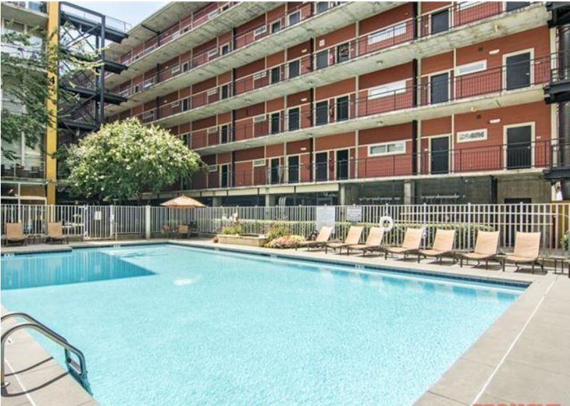 1016 Howell Mill Road, Unit 4604 Atlanta, GA 30318 - Photo 15 of 19 a front view of a building with a swimming pool