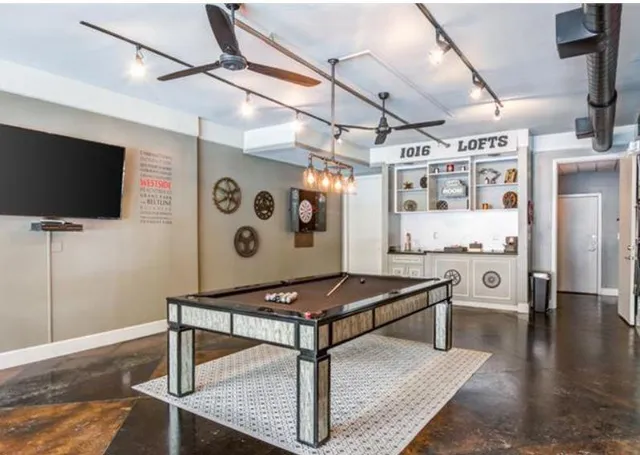 a view of backyard with a table and chairs under an umbrella