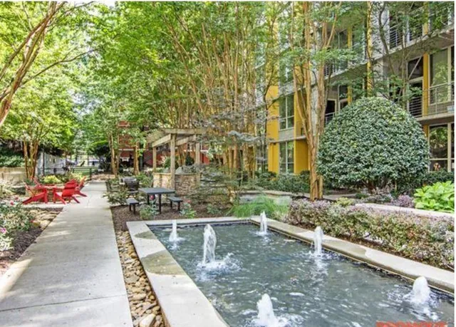 a view of a building with a yard and sitting area