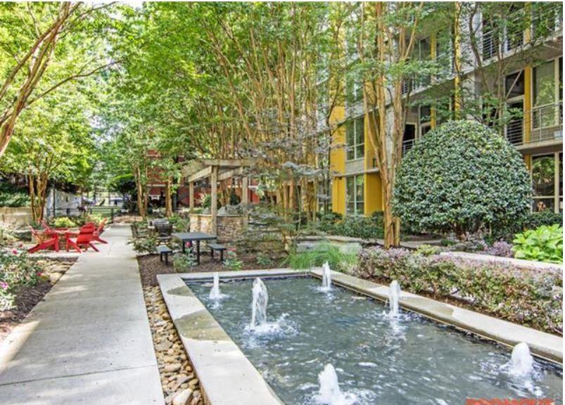 1016 Howell Mill Road, Unit 4604 Atlanta, GA 30318 - Photo 2 of 19 a view of a building with a yard and sitting area