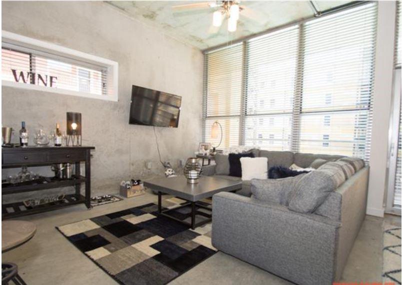 1016 Howell Mill Road, Unit 4604 Atlanta, GA 30318 - Photo 6 of 19 a living room with furniture and a flat screen tv