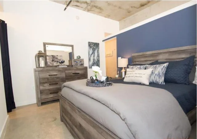 a bedroom with a bed and a mirror