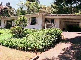 a view of a house with a yard and garden