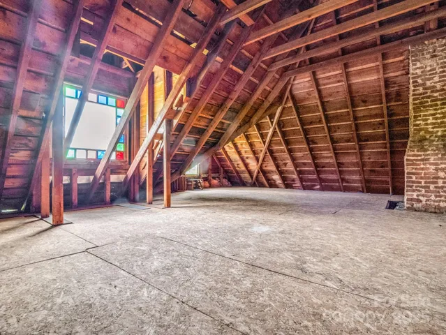 a view of empty room with wooden walls
