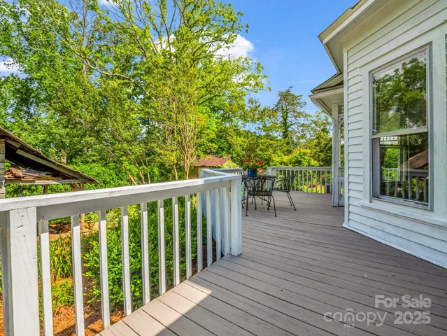 a balcony with wooden floor and outdoor space