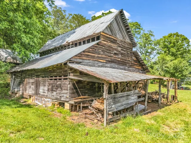a view of a house with a yard balcony and sitting area