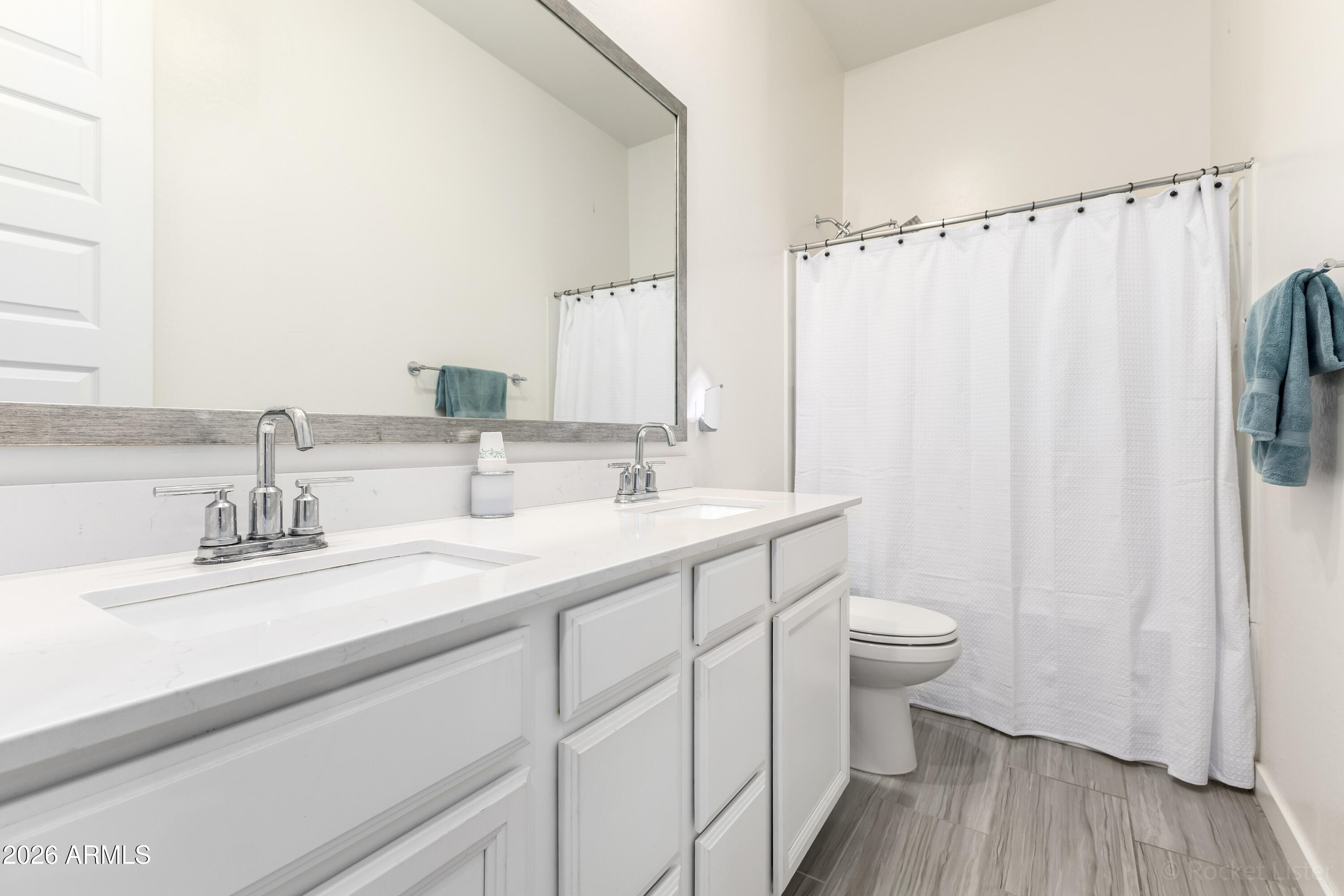23929 North 166th Lane Surprise, AZ 85387 - Photo 15 of 23 a bathroom with a double vanity sink toilet and a mirror