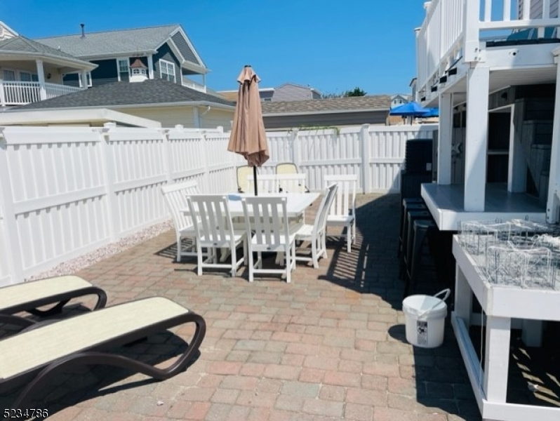 19 Haddonfield Avenue, Unit 1 Lavallette, NJ 08735 - Photo 4 of 13 a building outdoor space with patio furniture
