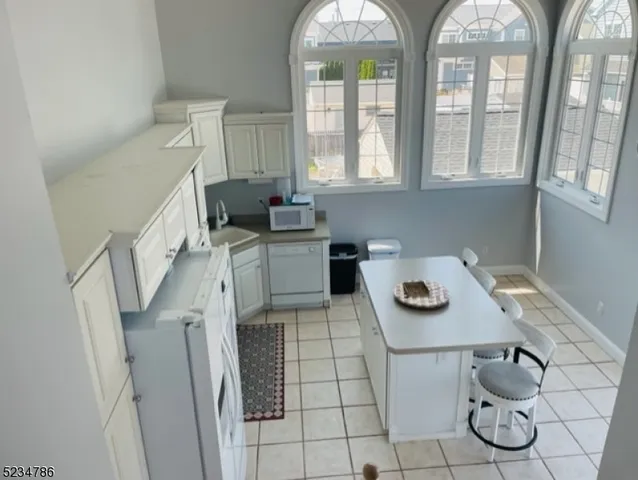a kitchen with furniture a stove a sink and a table