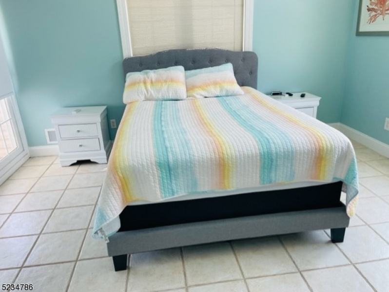 19 Haddonfield Avenue, Unit 1 Lavallette, NJ 08735 - Photo 8 of 13 a bedroom with a bed and a shower