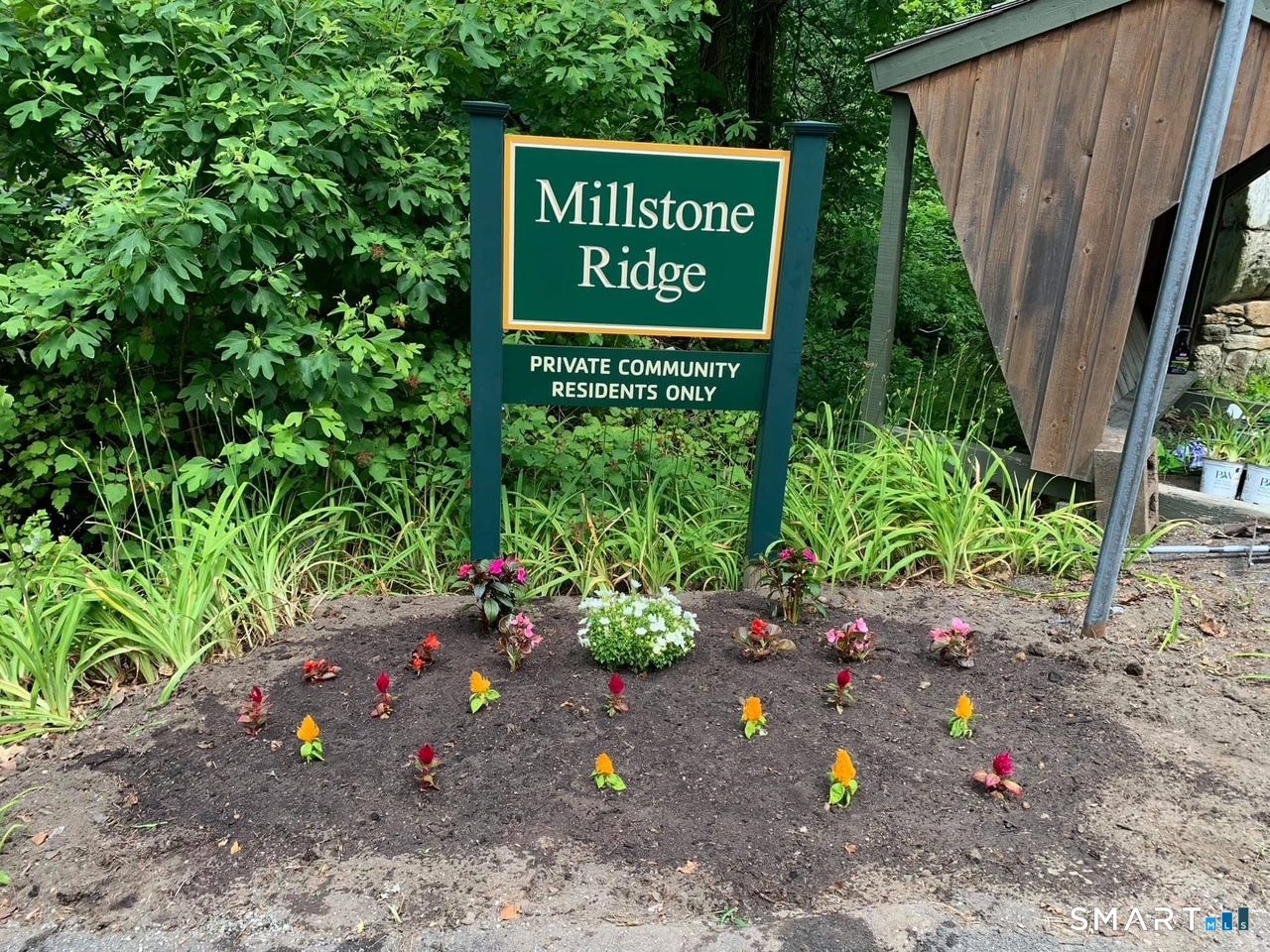 36 Maple Drive New Milford, CT 06776 - Photo 24 of 24 a sign that is sitting in front of flowers