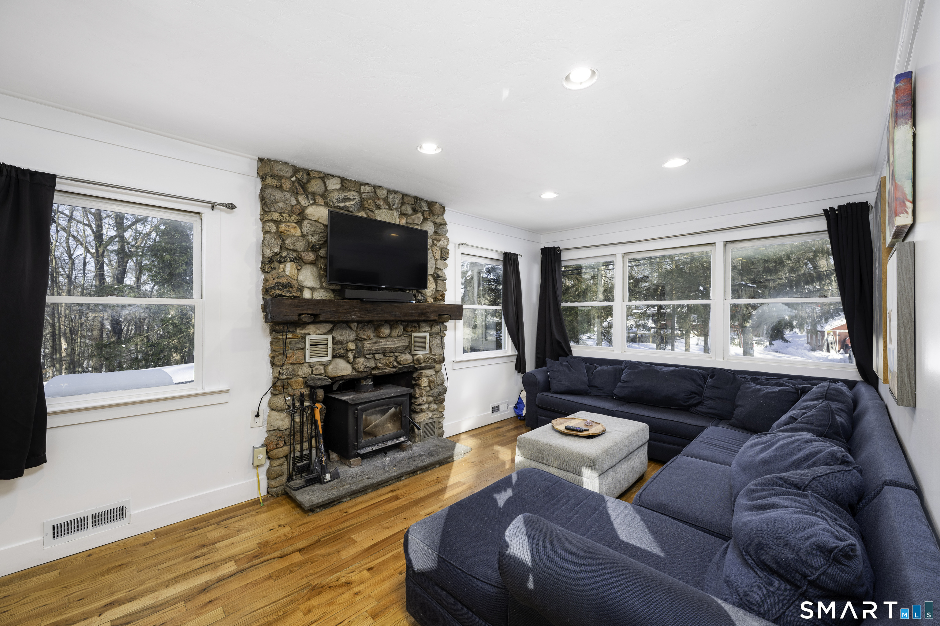 36 Maple Drive New Milford, CT 06776 - Photo 7 of 24 a living room with furniture a flat screen tv and a fireplace