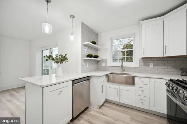 a kitchen with white cabinets and white appliances