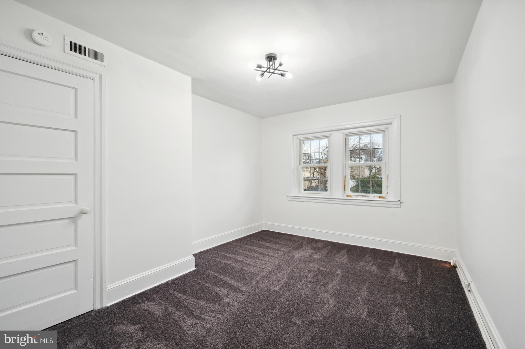 156 Edgemont Avenue Ardmore, PA 19003 - Photo 12 of 15 a view of empty room with window and chandelier fan