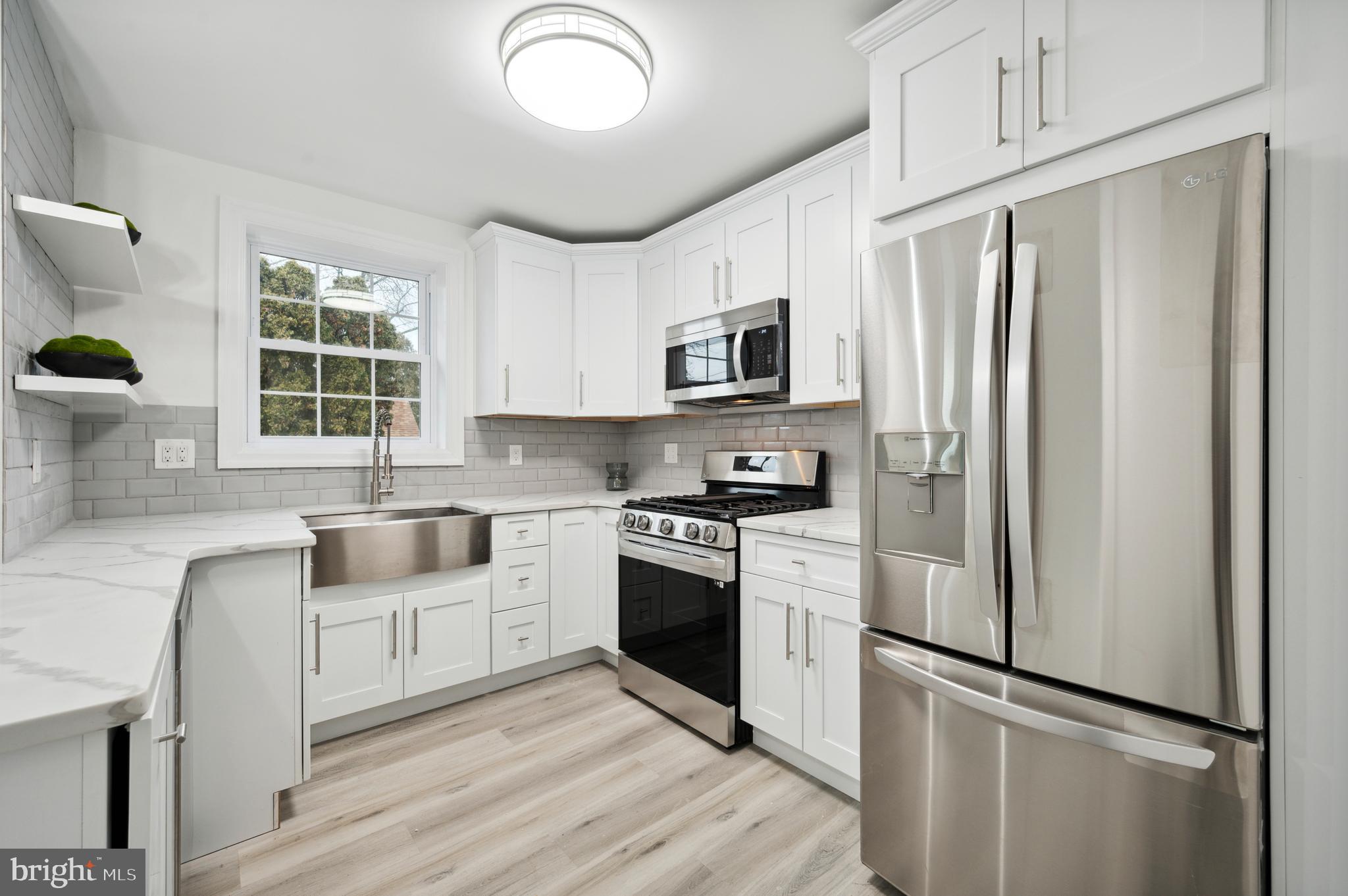 156 Edgemont Avenue Ardmore, PA 19003 - Photo 2 of 15 a kitchen with stainless steel appliances a refrigerator sink and microwave