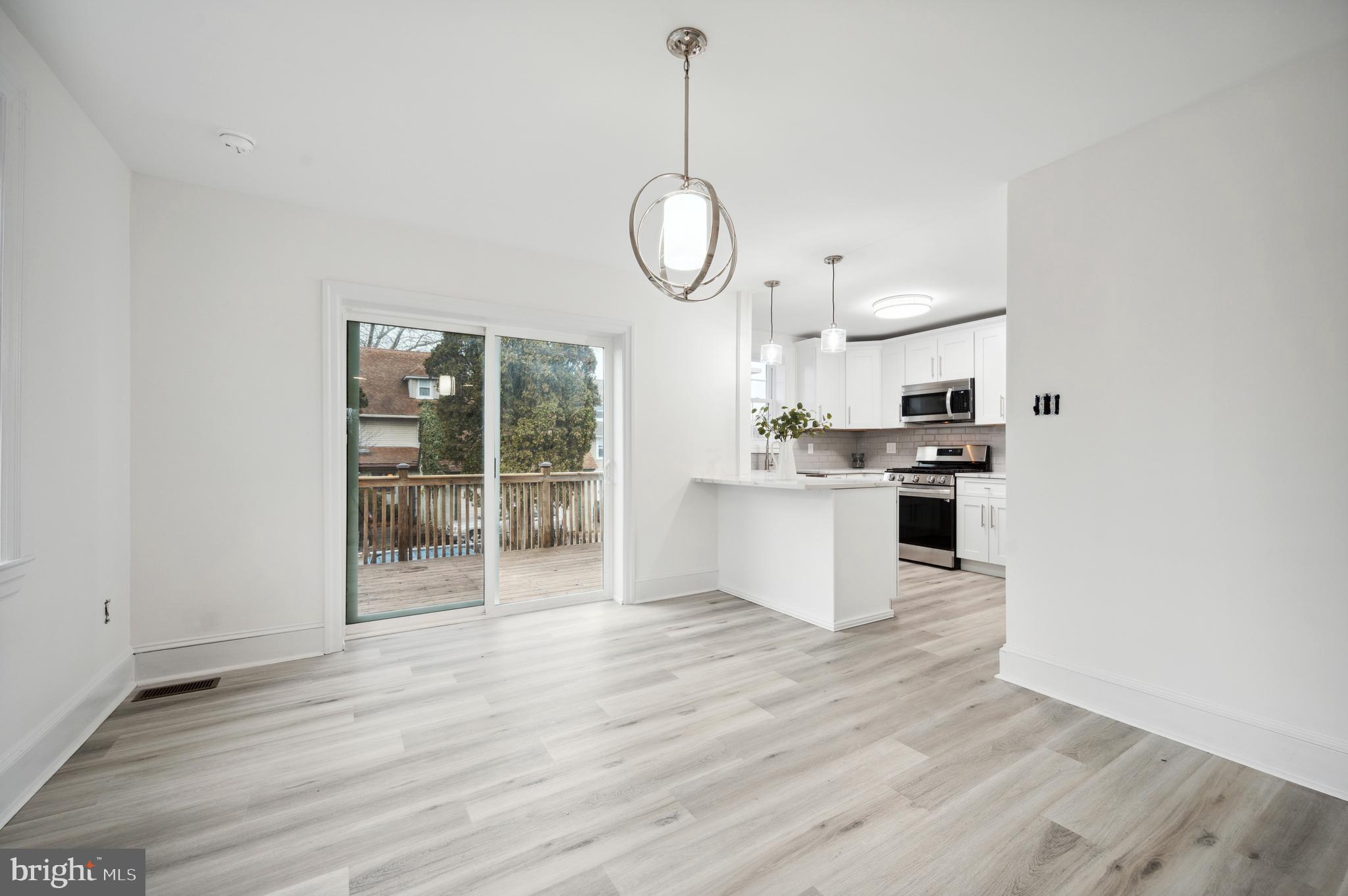 156 Edgemont Avenue Ardmore, PA 19003 - Photo 3 of 15 a large kitchen with cabinets wooden floor and stainless steel appliances