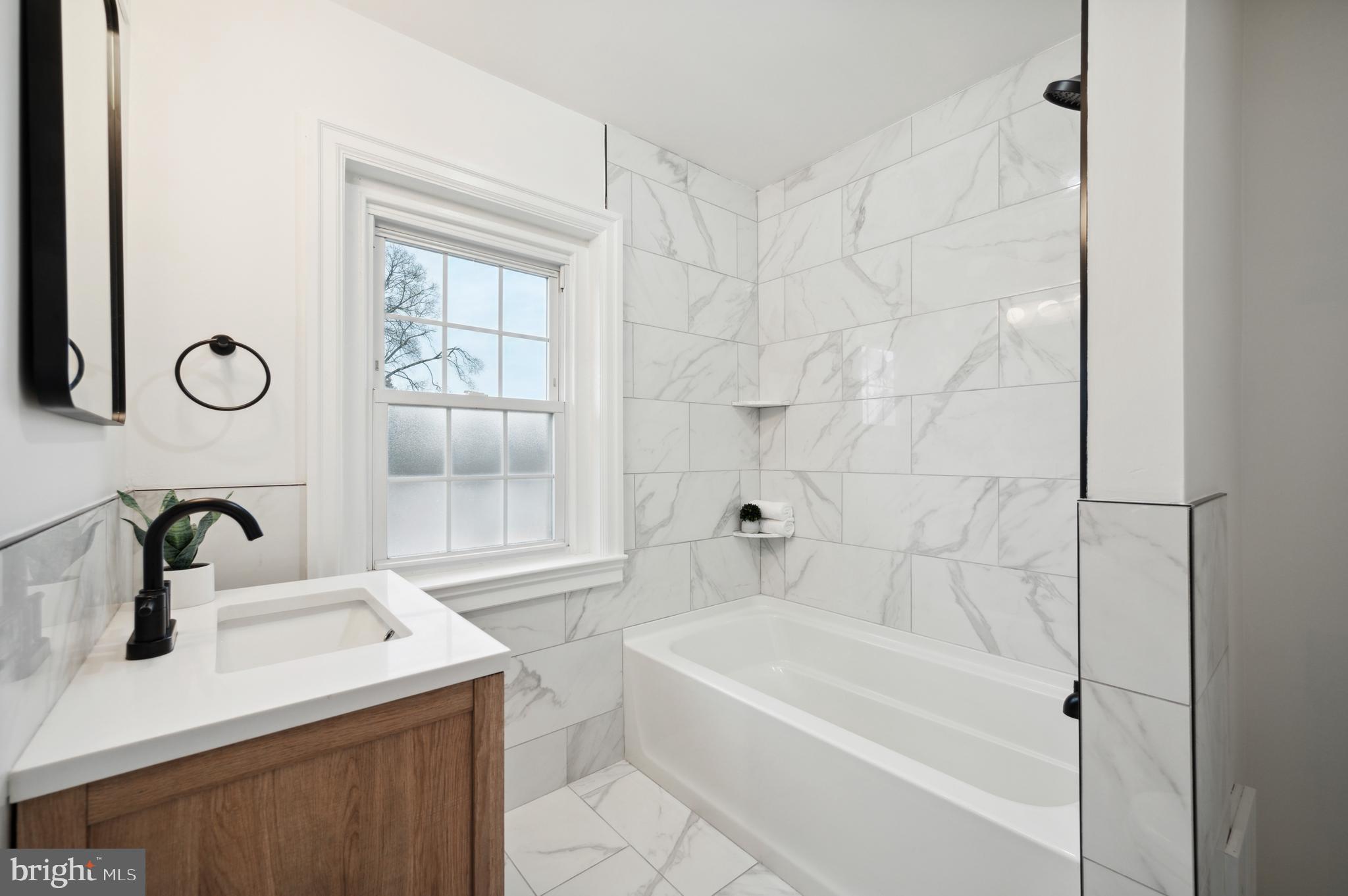 156 Edgemont Avenue Ardmore, PA 19003 - Photo 6 of 15 a bathroom with a sink a mirror and a bathtub