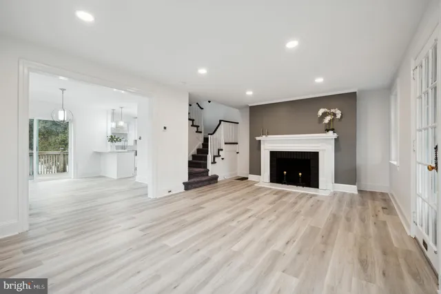 a view of a livingroom with a fireplace wooden floor and window