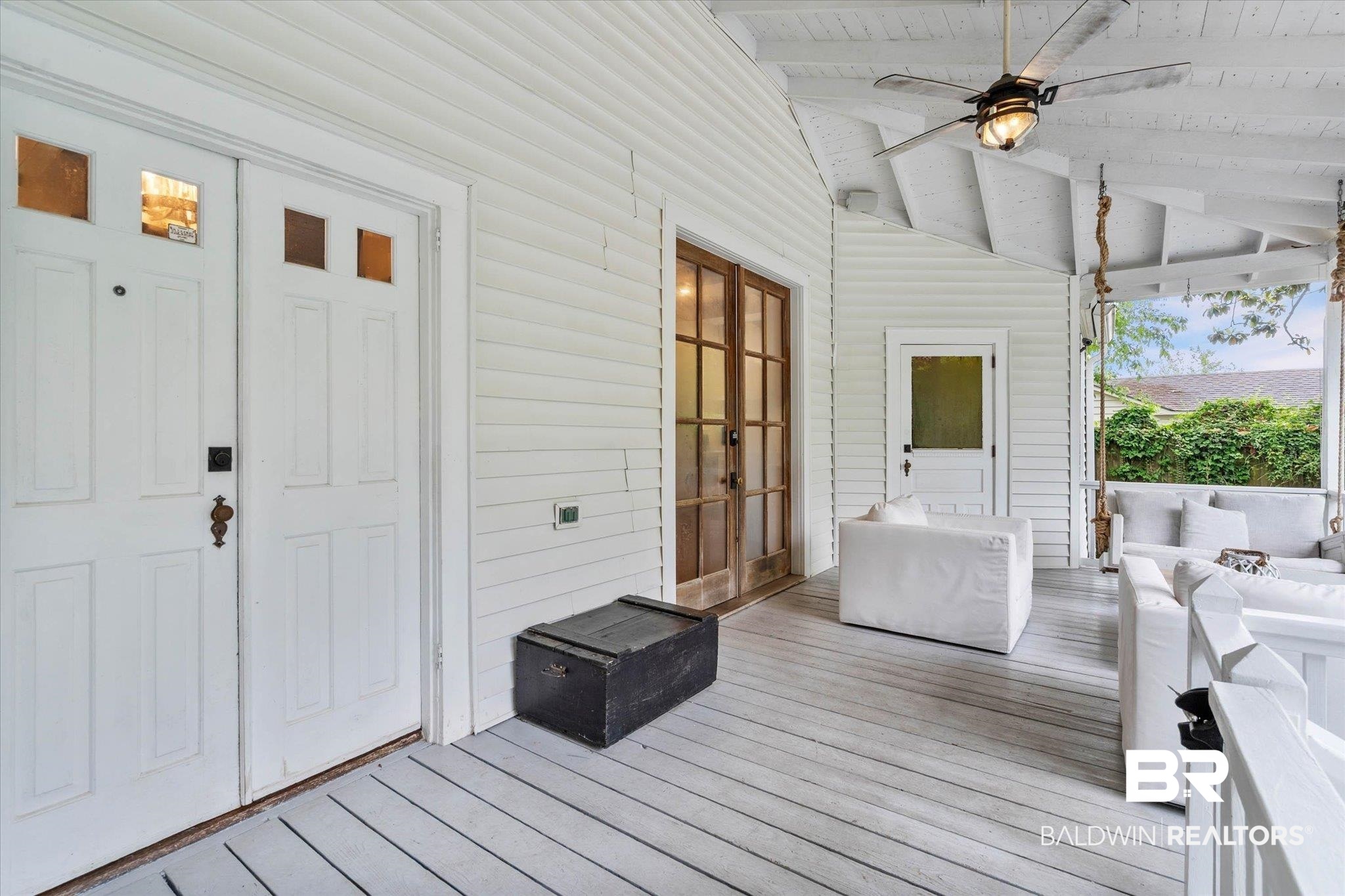 3863 Old Shell Road Mobile, AL 36608 - Photo 15 of 48 Expansive covered porch featuring a painted wood plank floor and ceiling, a ceiling fan with integrated lighting, and white horizontal siding