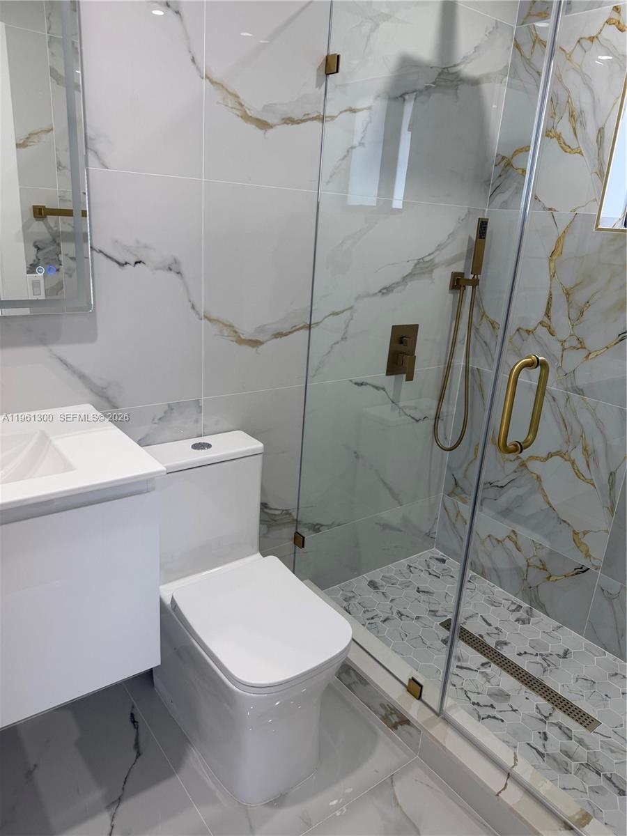 18940 Southwest 113th Court Miami, FL 33157 - Photo 22 of 30 a white toilet sitting next to a bathroom sink