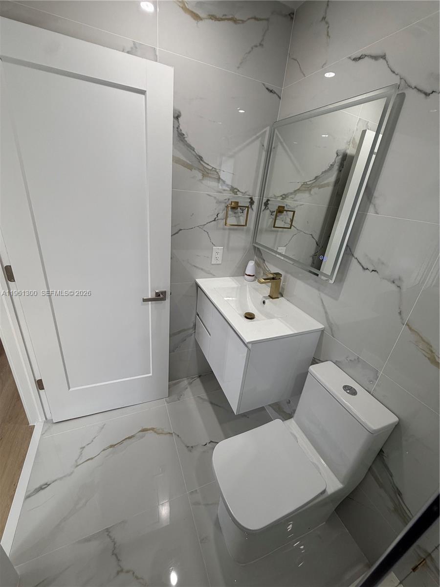 18940 Southwest 113th Court Miami, FL 33157 - Photo 24 of 30 a bathroom with a sink a toilet and shower