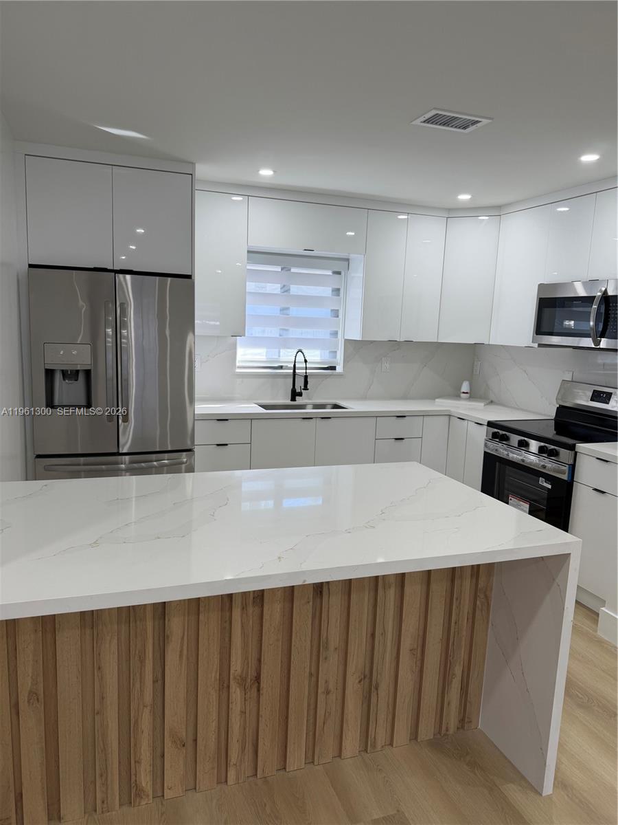 18940 Southwest 113th Court Miami, FL 33157 - Photo 8 of 30 a kitchen with stainless steel appliances a refrigerator sink and microwave
