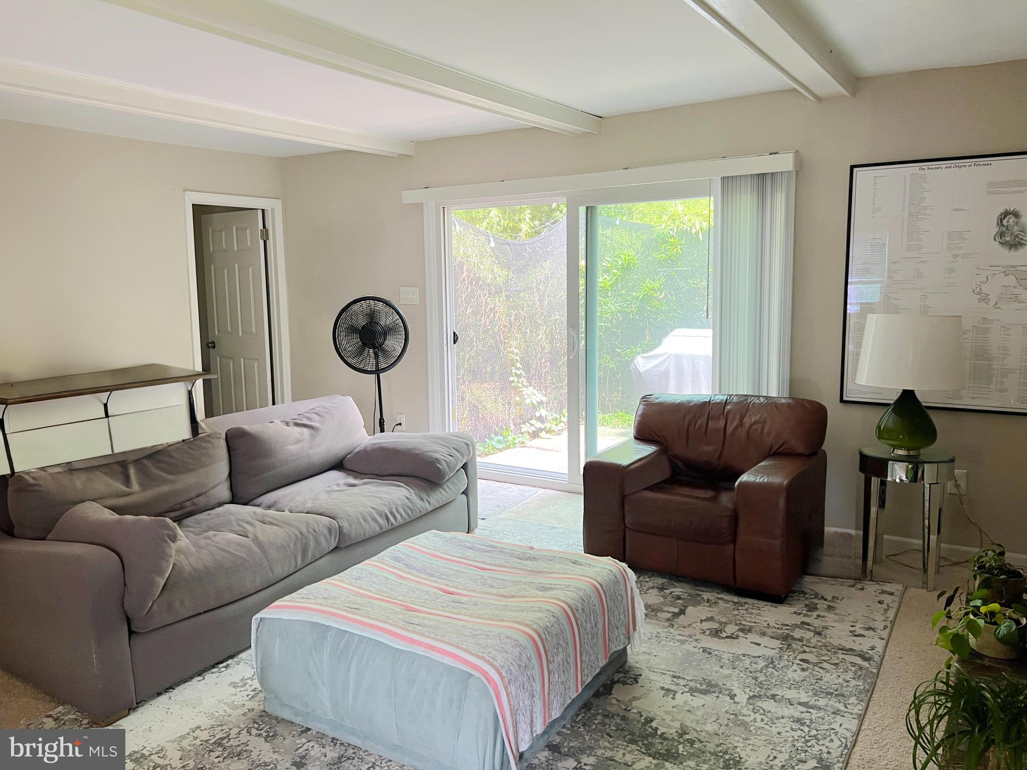 203 Spring Drive Voorhees, NJ 08043 - Photo 12 of 21 a living room with couches a lamp and a large window with garden view