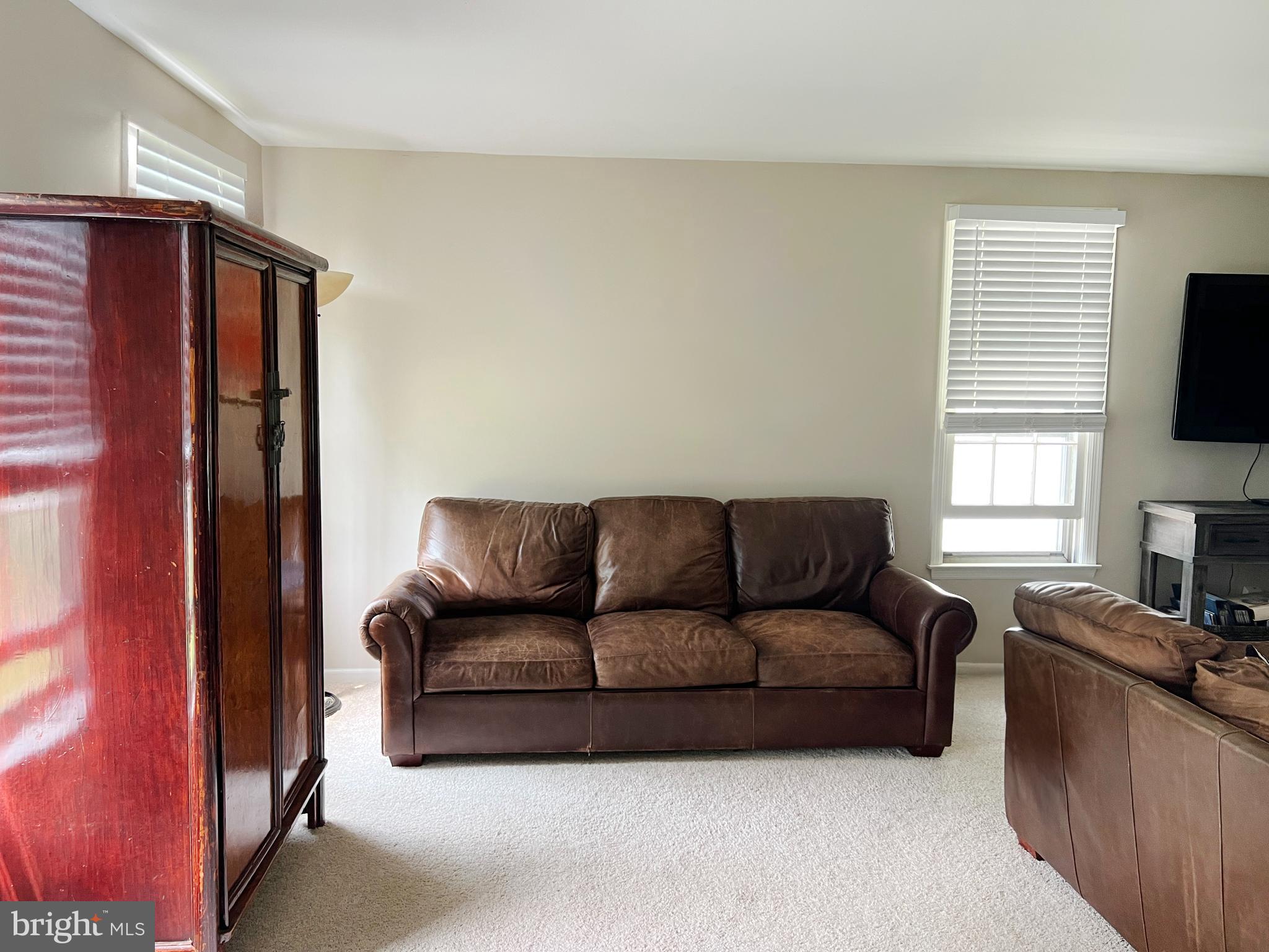 203 Spring Drive Voorhees, NJ 08043 - Photo 7 of 21 a living room with furniture a flat screen tv and a window