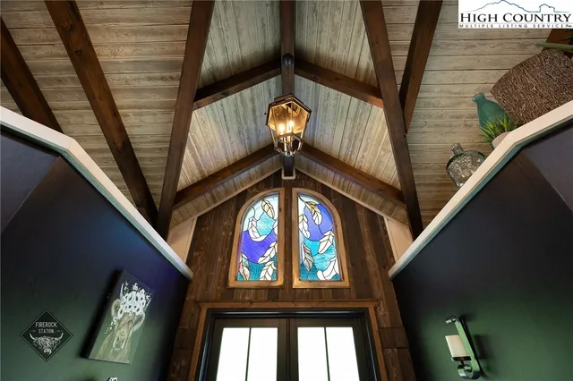 a view of staircase with a lots of frames on wall