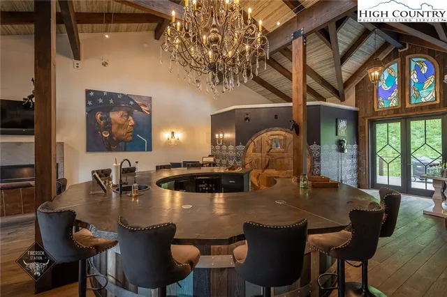 a view of a dining room with furniture and chandelier