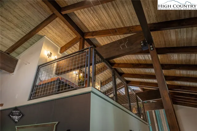 a bedroom with a bed and large windows