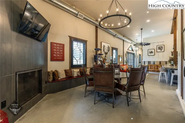 a dining room with furniture and a chandelier