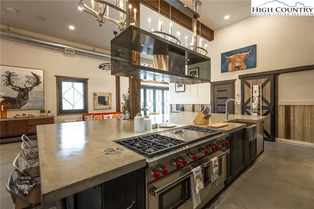 a kitchen with stainless steel appliances wooden cabinets and a stove top oven