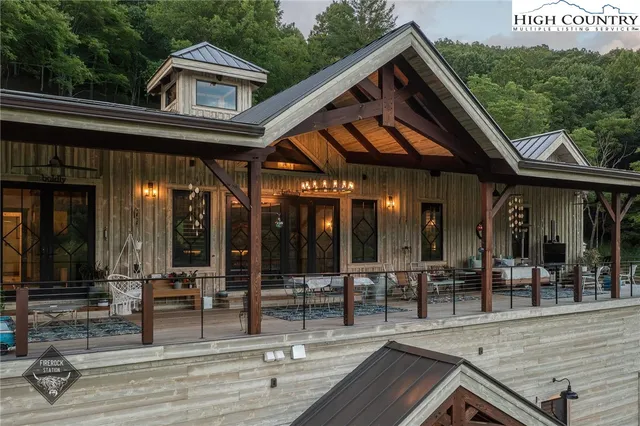 an aerial view of a house with swimming pool and sitting area