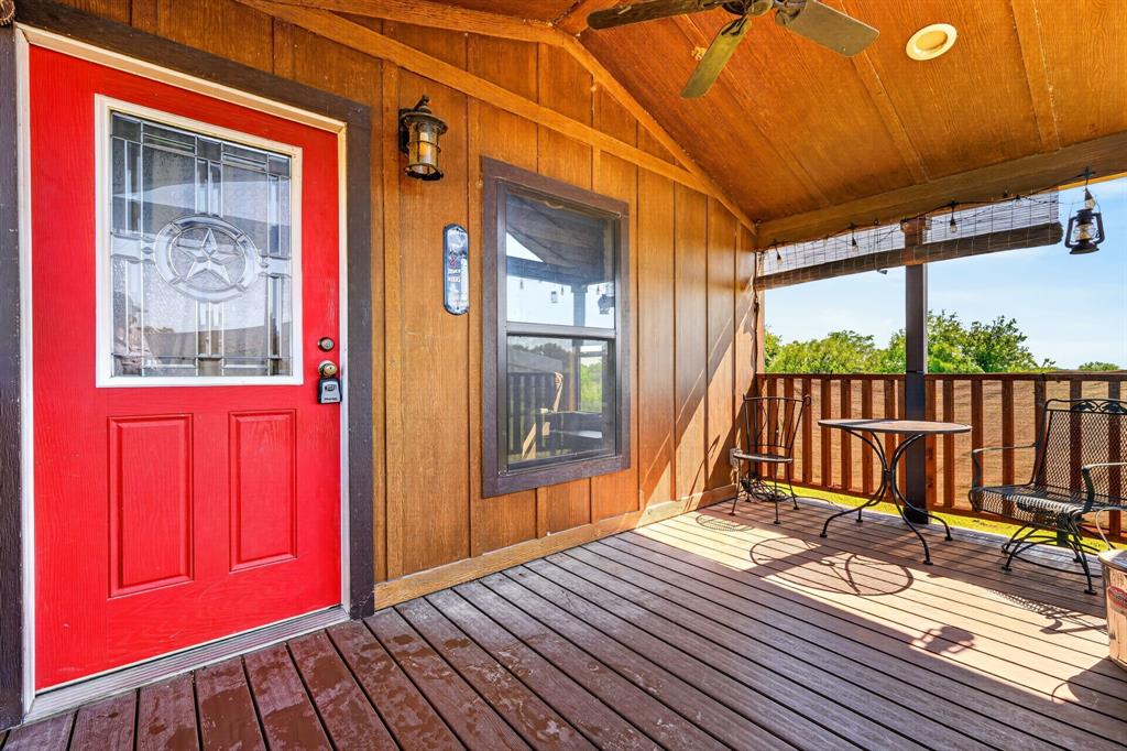 2401 Lamkin Road Mineral Wells, TX 76067 - Photo 6 of 36 a view of a balcony with wooden floor and fence