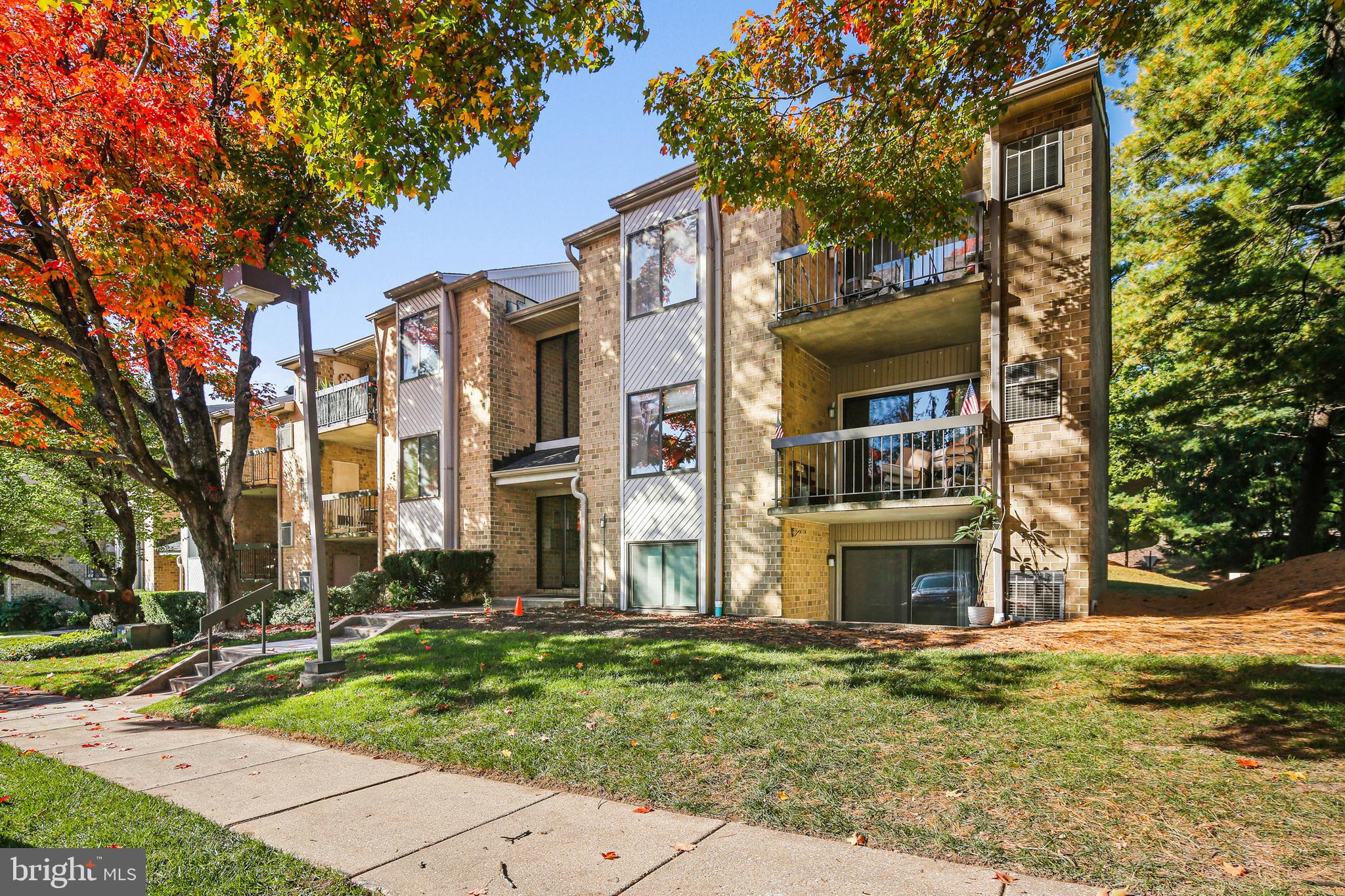2 Bailiffs Court, Unit 102 Lutherville-Timonium, MD 21093 - Photo 1 of 34 a front view of a residential apartment building with a yard