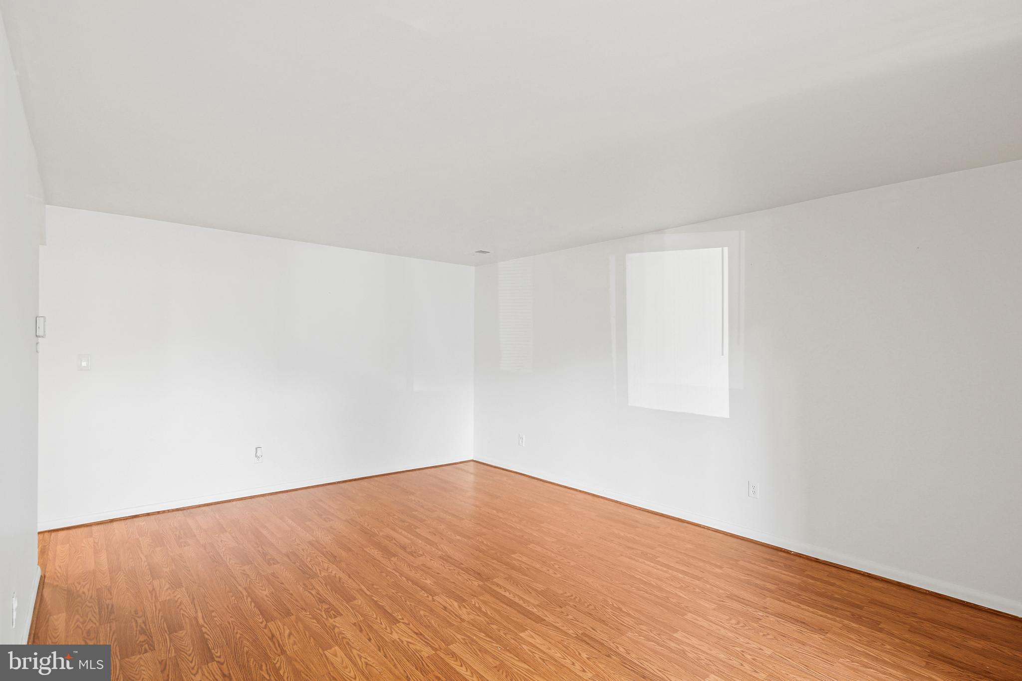 2 Bailiffs Court, Unit 102 Lutherville-Timonium, MD 21093 - Photo 13 of 34 a view of an empty room with wooden floor